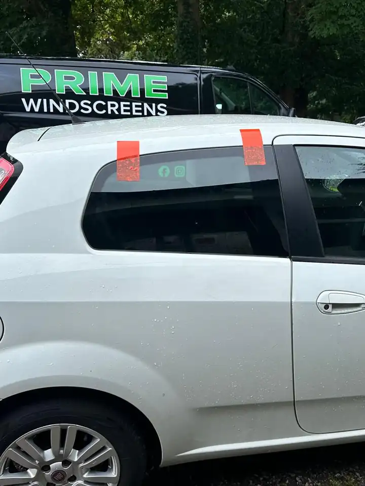 After: the same Fiat Punto in Enfield with a new rear side window taped in place