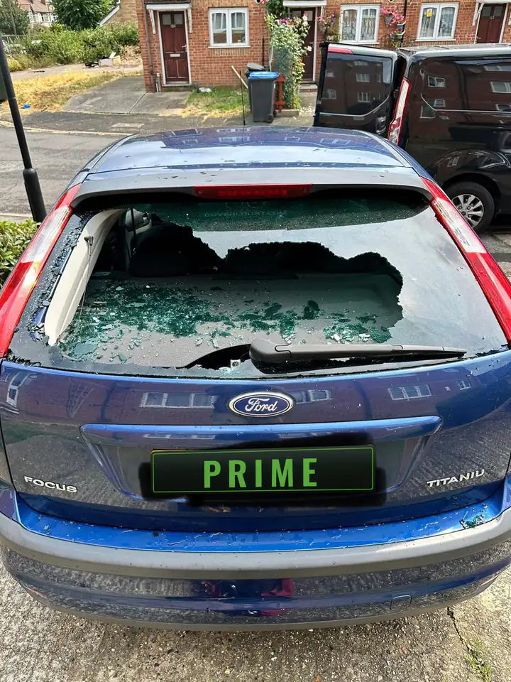 Before: blue Ford Focus on a Barking street with its rear screen smashed