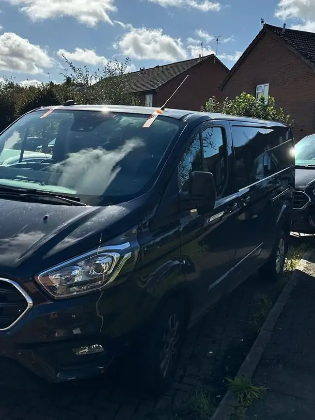 After: the same Ford Transit Custom with its new windscreen fitted and orange tape along the top edge