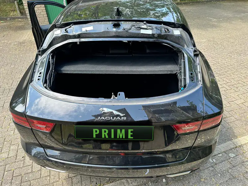 Black Jaguar E Pace with its tailgate glass taken out, the empty frame and wiring ready for the new rear screen