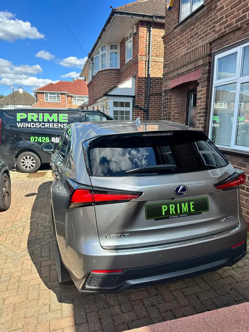 Grey Lexus NX on a driveway in Edgware after a rear screen replacement, with the Prime Windscreens van behind