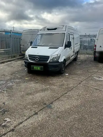 The same white Mercedes Sprinter refrigerated van in the fenced yard with its new windscreen fitted