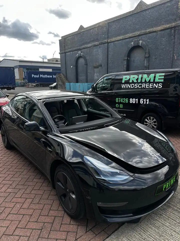 Before: black Tesla Model 3 with the damaged windscreen removed, parked next to the Prime Windscreens van